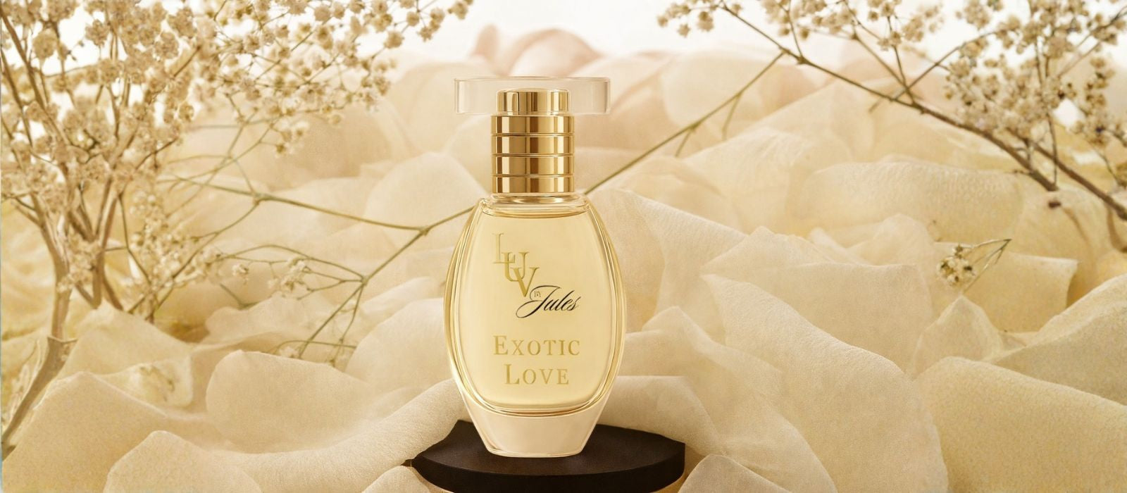 Perfume bottle labeled 'Exotic Love' on a soft white floral background