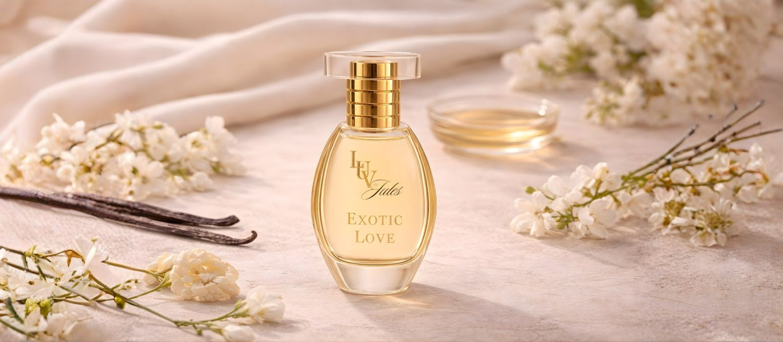 Perfume bottle labeled 'Exotic Love' with vanilla beans and flowers on a light background